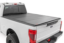 Load image into Gallery viewer, Hard Tri-Fold Flip Up Bed Cover 6 Foot 10 Inch Bed Ford F-250/F-350 Super Duty (17-26) Rough Country