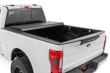 Load image into Gallery viewer, Hard Tri-Fold Flip Up Bed Cover 6 Foot 10 Inch Bed Ford F-250/F-350 Super Duty (17-26) Rough Country