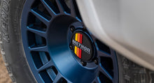Load image into Gallery viewer, Method Wheels Push Through Center Cap | 108mm | Black with Yellow / Orange / Red Stripes