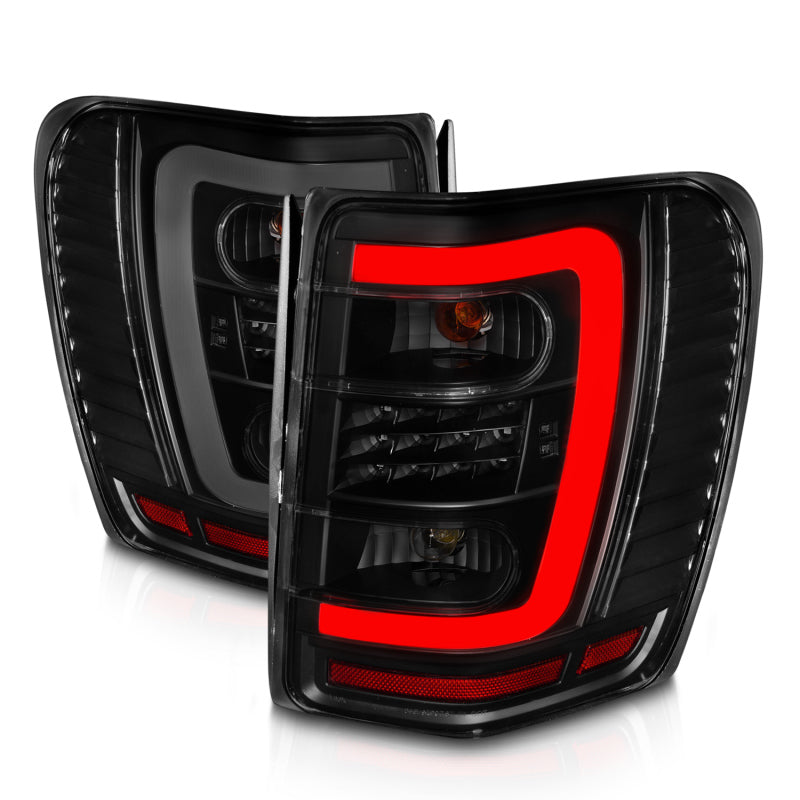 ANZO 1999-2004 Jeep Grand Cherokee luces traseras LED con barra de luz, carcasa negra, lente ahumada