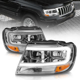 ANZO 1999-2004 Jeep Grand Cherokee Faros delanteros de cristal con barra de luz y carcasa cromada