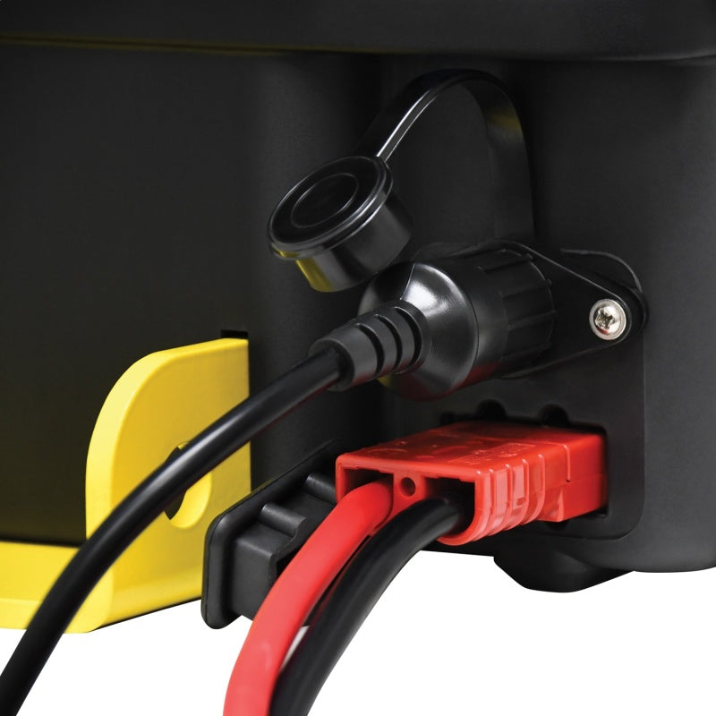 A black steel cable winch with a yellow handle, accompanied by various accessories including a power cord, snatch block, straps, shackles, and winch gloves.