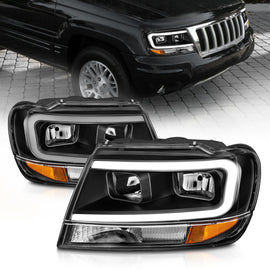 Faros delanteros de cristal ANZO 99-04 Jeep Grand Cherokee - con barra de luz y carcasa negra